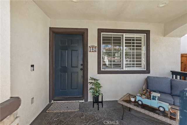 entrance to property with stucco siding