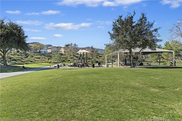 surrounding community featuring playground community and a lawn