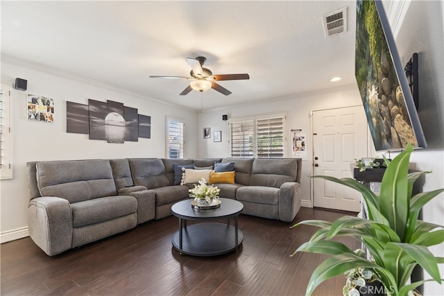 living area featuring ceiling fan, wood finished floors, visible vents, baseboards, and ornamental molding