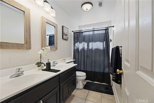 bathroom with toilet, tile patterned flooring, visible vents, and a sink