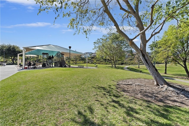 view of community featuring playground community and a yard