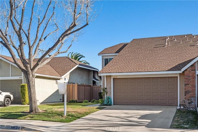 view of front of home featuring roof with shingles, stucco siding, concrete driveway, fence, and a garage