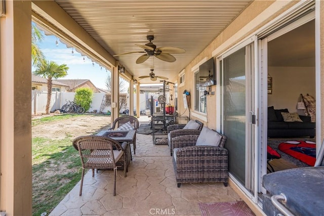 view of patio featuring an outdoor living space, a fenced backyard, and a ceiling fan