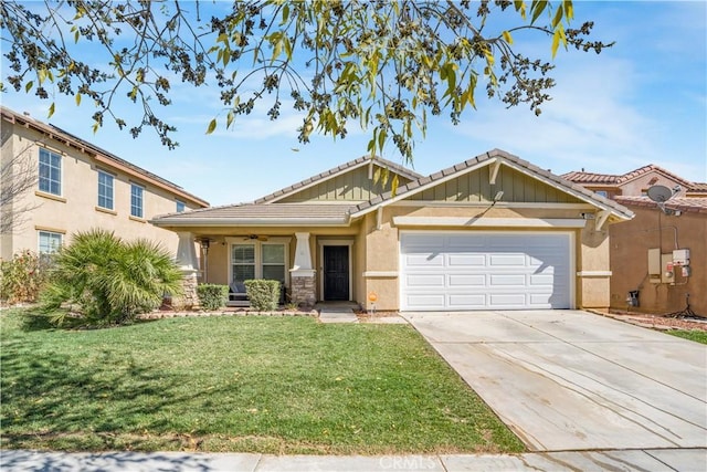 view of front of property with a tile roof, stucco siding, a front yard, a garage, and driveway