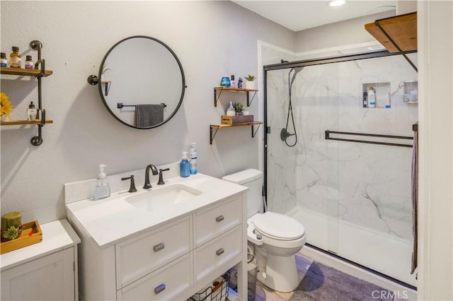 bathroom featuring toilet, vanity, and a marble finish shower