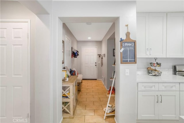 kitchen with recessed lighting, white cabinets, light countertops, and light tile patterned flooring