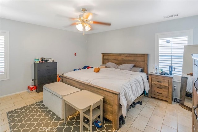 bedroom featuring light tile patterned flooring, visible vents, and multiple windows