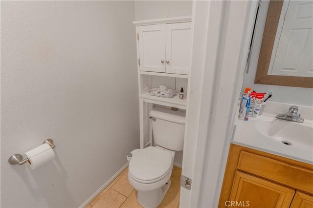 bathroom with toilet, tile patterned flooring, baseboards, and vanity