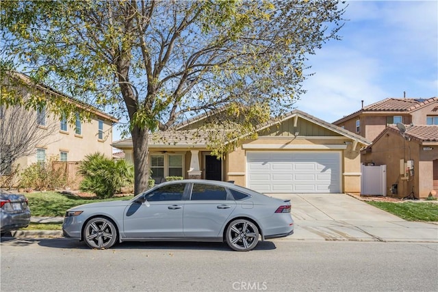 view of front of home featuring concrete driveway, an attached garage, and stucco siding