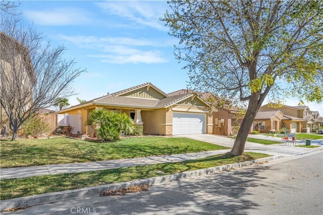 view of front of house with driveway, a garage, a tiled roof, fence, and stucco siding