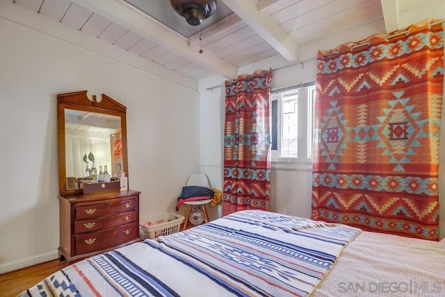 bedroom featuring wood ceiling, beam ceiling, and wood-type flooring