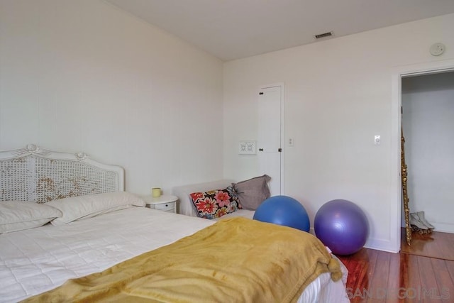 bedroom with wood-type flooring