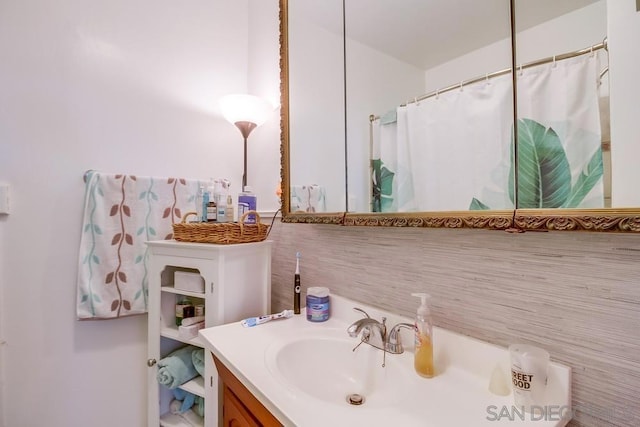 bathroom featuring vanity and a shower with shower curtain