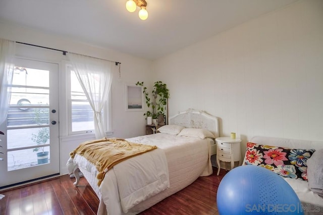 bedroom with dark hardwood / wood-style floors