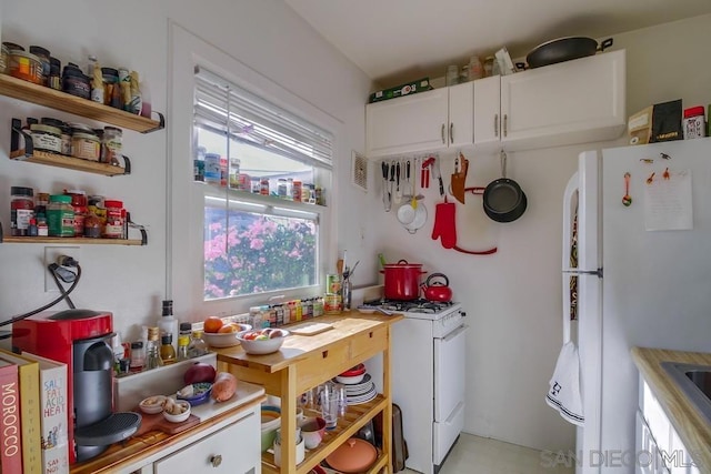 kitchen with white appliances and white cabinets