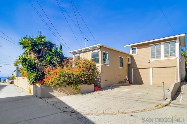 rear view of property featuring a garage