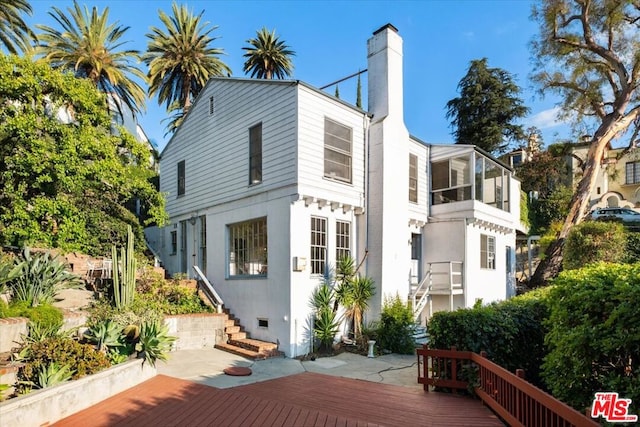 back of house with a patio and a deck