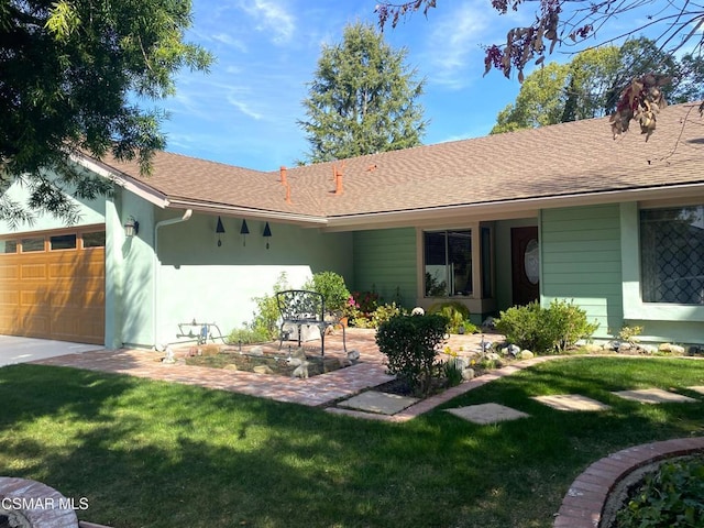 view of front of home featuring a garage and a front lawn