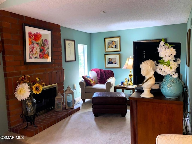 sitting room featuring a brick fireplace, a textured ceiling, and carpet