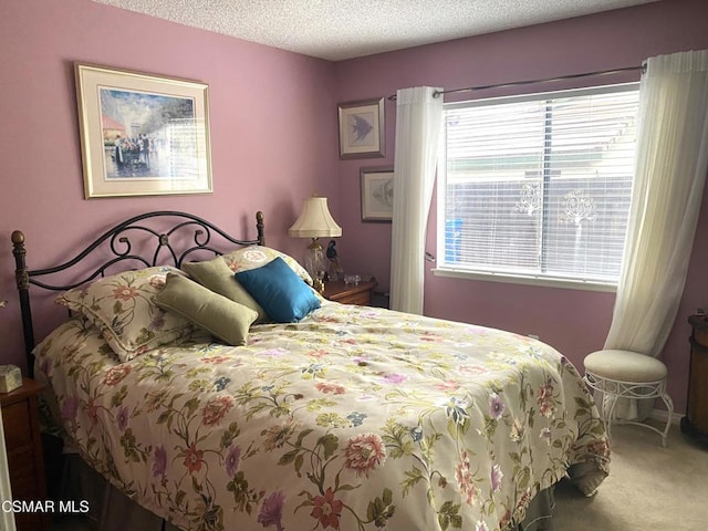 bedroom with carpet flooring and a textured ceiling