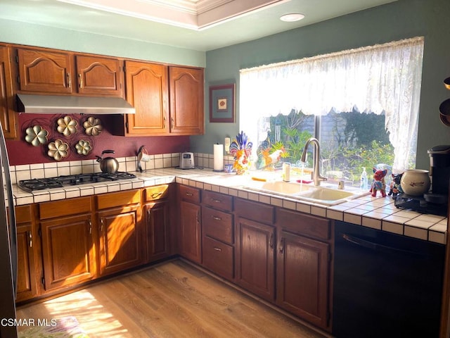 kitchen featuring sink, dishwasher, a wealth of natural light, tile countertops, and stainless steel gas stovetop