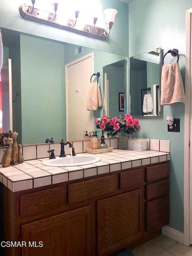 bathroom with vanity and tile patterned flooring