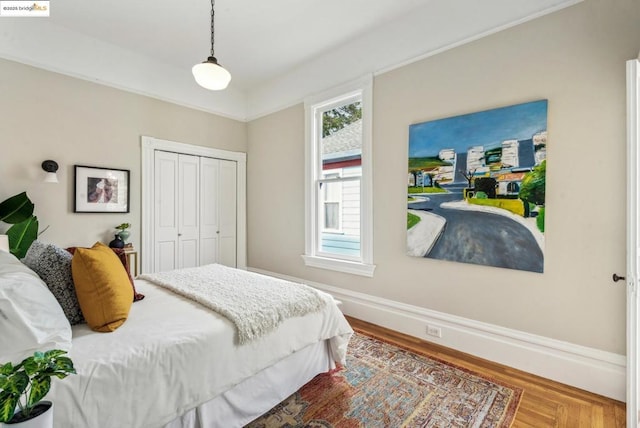 bedroom featuring hardwood / wood-style floors and a closet