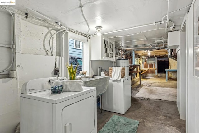 washroom featuring water heater and washer and dryer