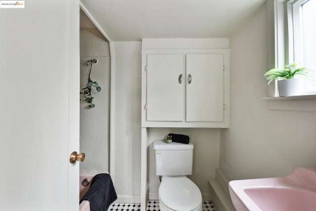 bathroom featuring walk in shower and toilet