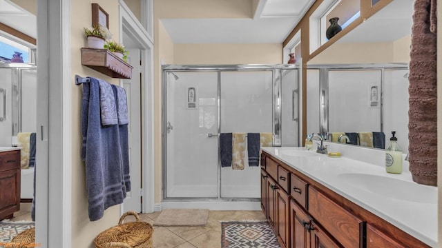 bathroom featuring vanity, tile patterned floors, and a shower with shower door