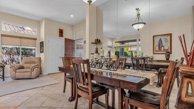 tiled dining area with a wealth of natural light and ceiling fan