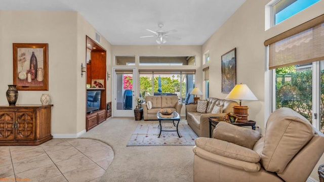 tiled living room with plenty of natural light and ceiling fan