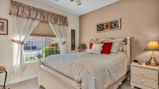 bedroom featuring light carpet and ceiling fan