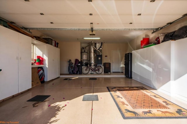 garage with water heater and black refrigerator