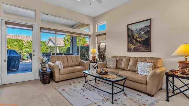 living room with a wealth of natural light, light colored carpet, and ceiling fan