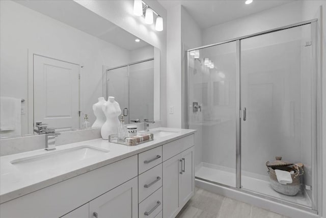 bathroom with vanity and a shower with shower door