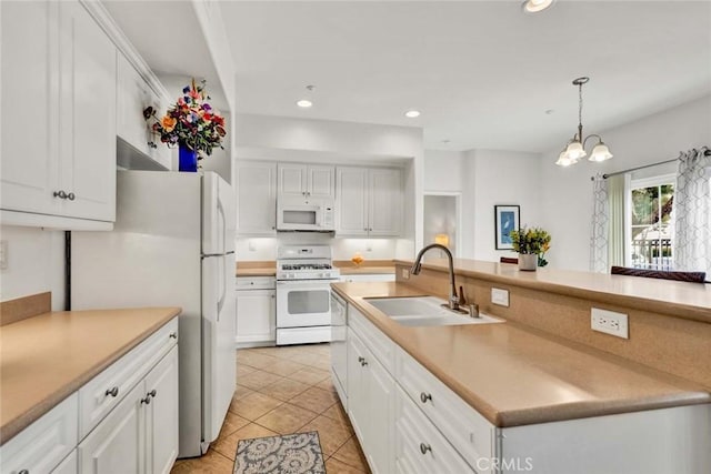 kitchen with sink, white appliances, and white cabinets