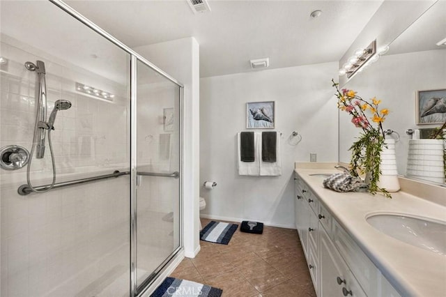 bathroom featuring tile patterned flooring, vanity, an enclosed shower, and toilet