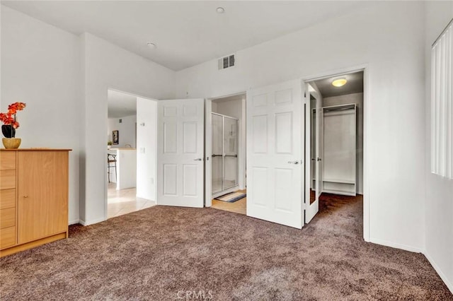 unfurnished bedroom featuring a closet, carpet floors, and a spacious closet