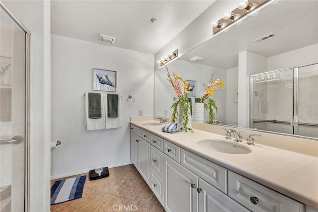 bathroom featuring tile patterned floors, vanity, and an enclosed shower