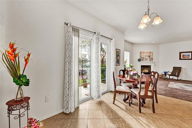 dining area with a chandelier and light tile patterned floors