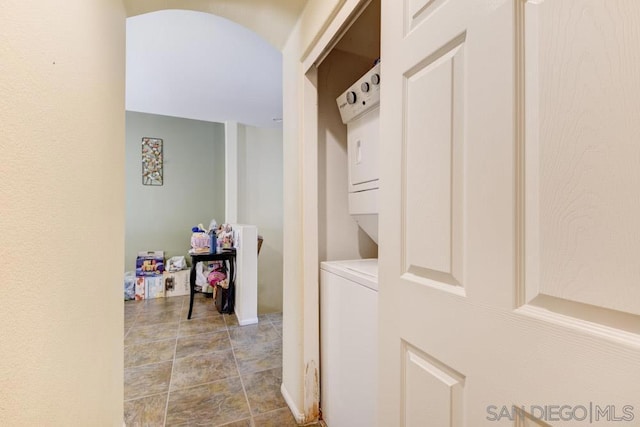 mudroom featuring stacked washer and clothes dryer