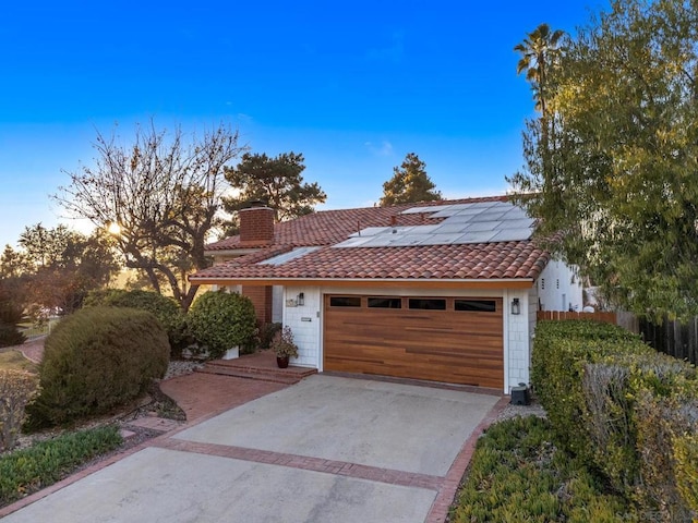 view of front of property featuring solar panels