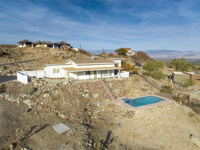 rear view of house with a patio and a mountain view