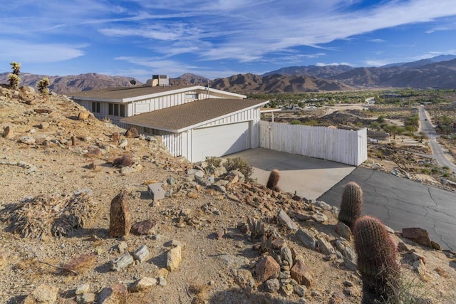 view of home's exterior featuring a garage and a mountain view