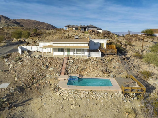 view of swimming pool featuring a mountain view and a patio