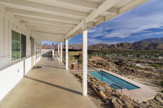 view of pool with a mountain view and a patio area