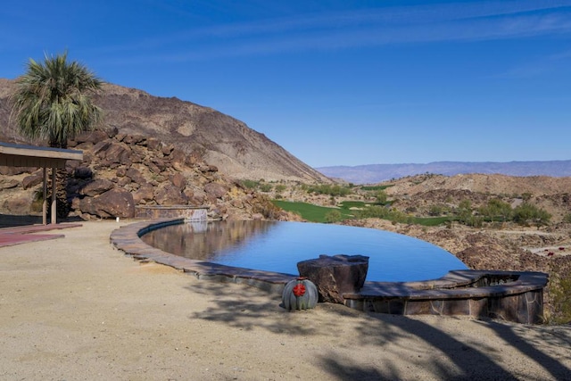 exterior space with a water and mountain view