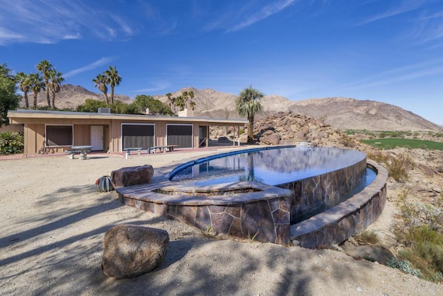 view of swimming pool with a mountain view and a patio area