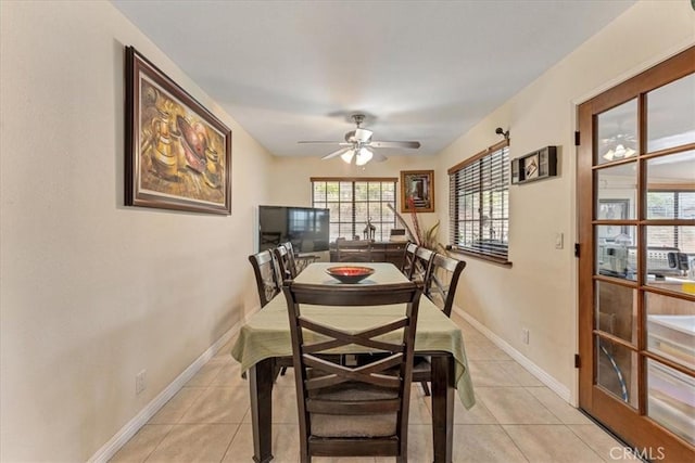 dining area with ceiling fan and light tile patterned flooring